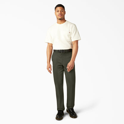 Man wearing a white t-shirt and green pants on a white background