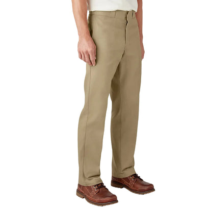 Person wearing beige pants and brown shoes on a white background