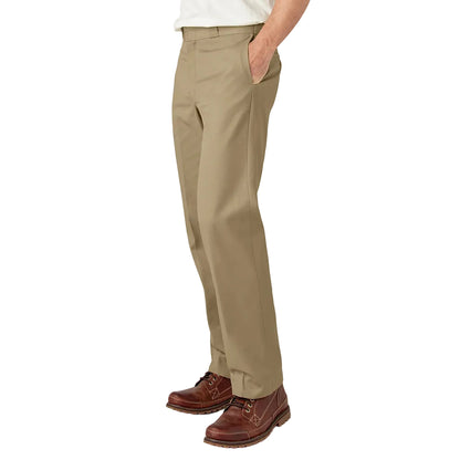 Person wearing beige pants and brown shoes on a white background