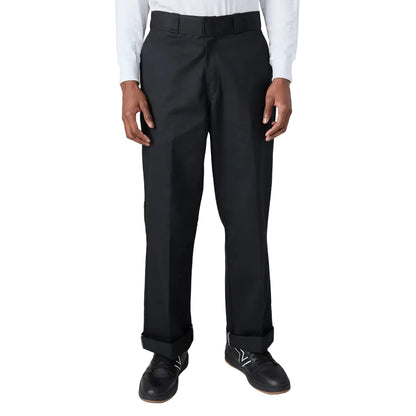 Black dress pants worn with a white shirt on a white background