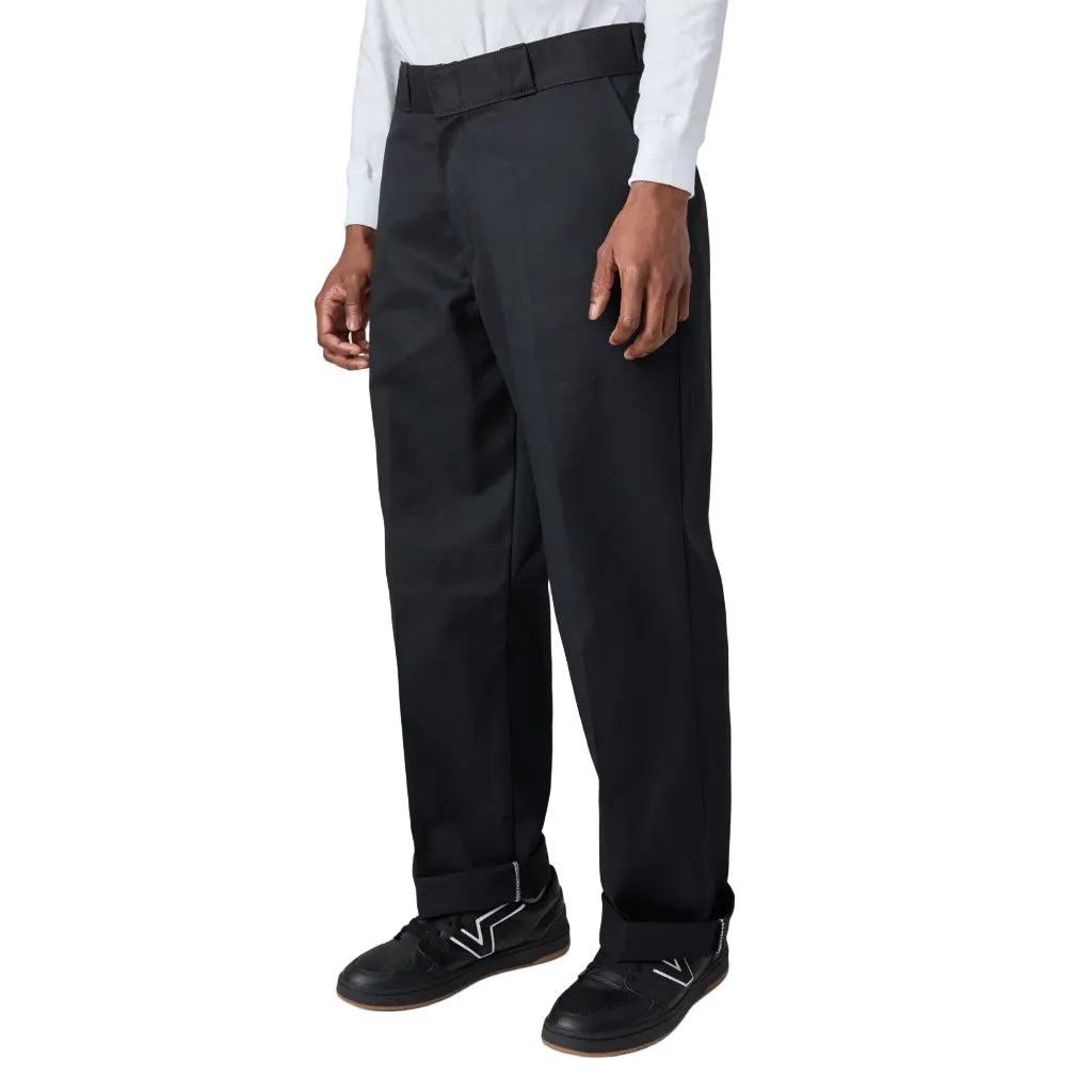 Person wearing black dress pants on a white background