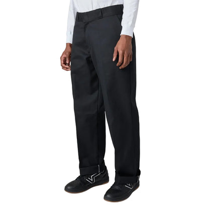 Person wearing black dress pants on a white background