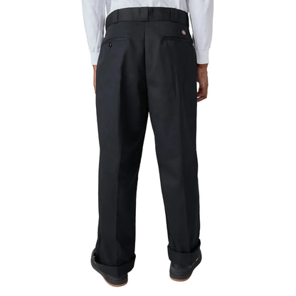 Black pleated pants worn by a person on a white background