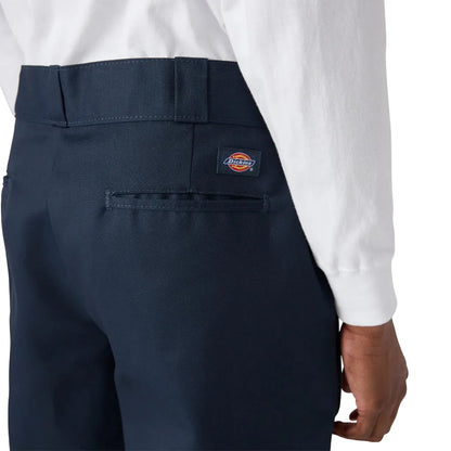 Navy pants with a Dickies logo on the pocket against a white background