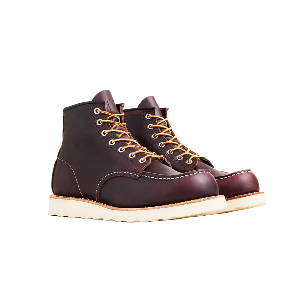 Pair of brown leather boots with yellow laces on a white background