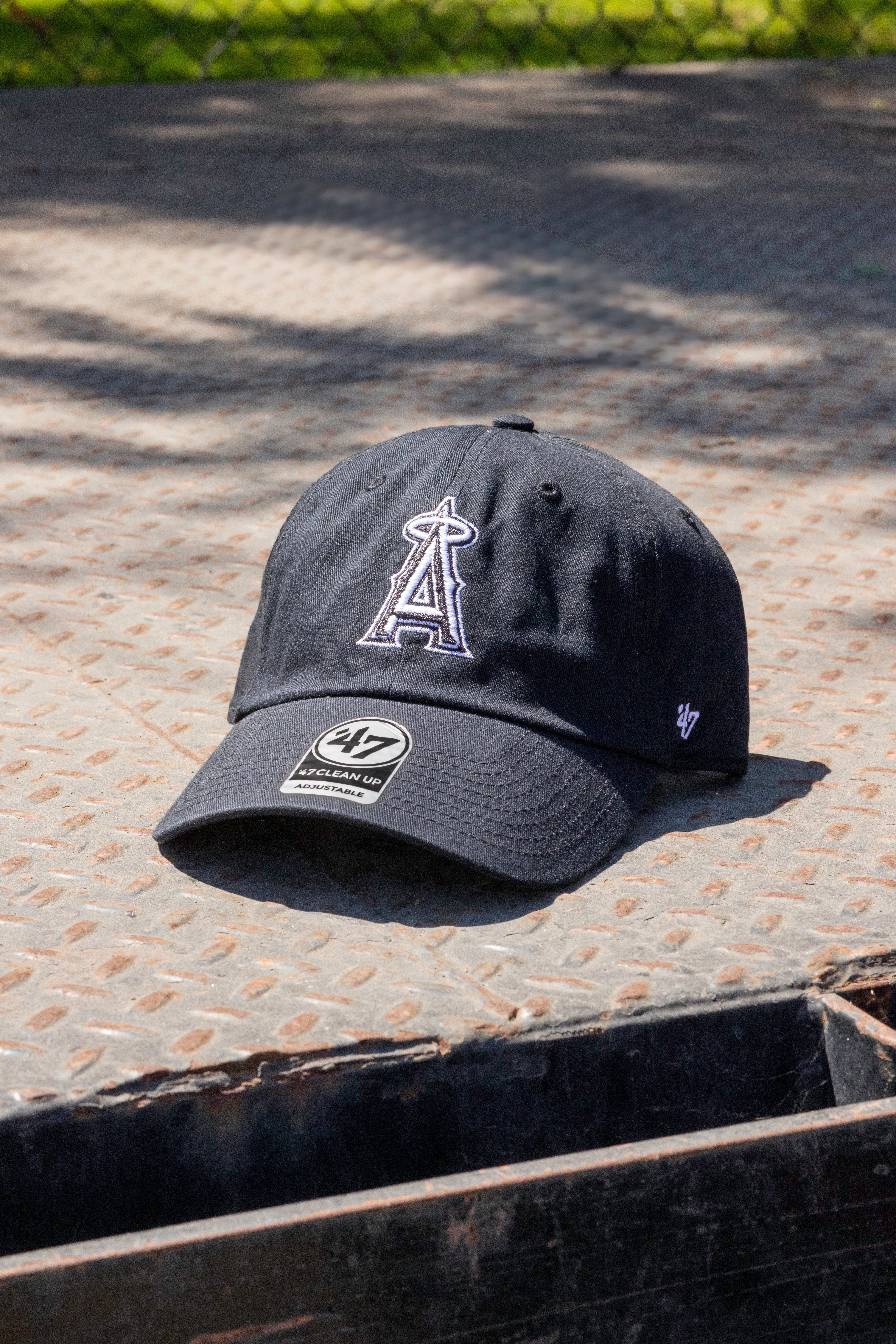 Black cap with a logo on a textured surface