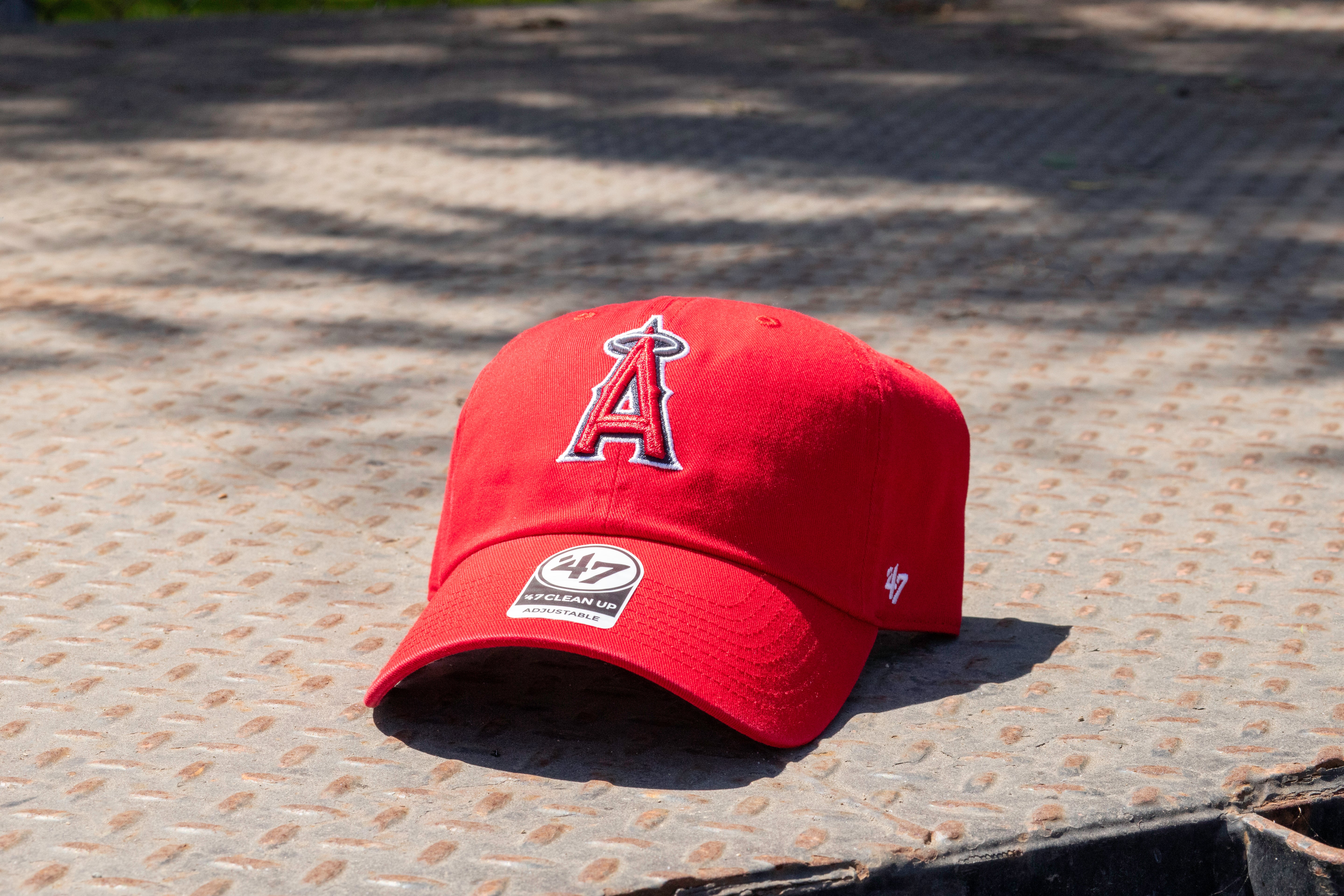 Red baseball cap with a logo on a textured surface