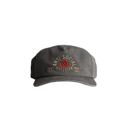Green bucket hat with a decorative emblem on a light gray background