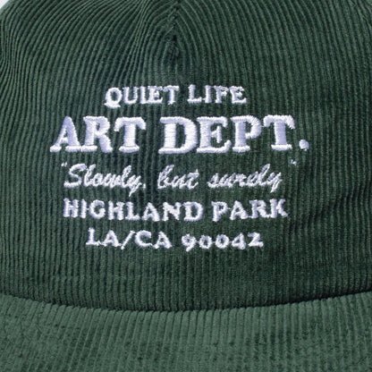 Green cap with white embroidered text on a green background