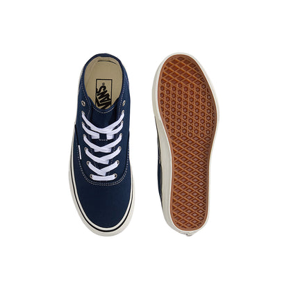 Navy blue sneaker with white laces and brown sole on a white background