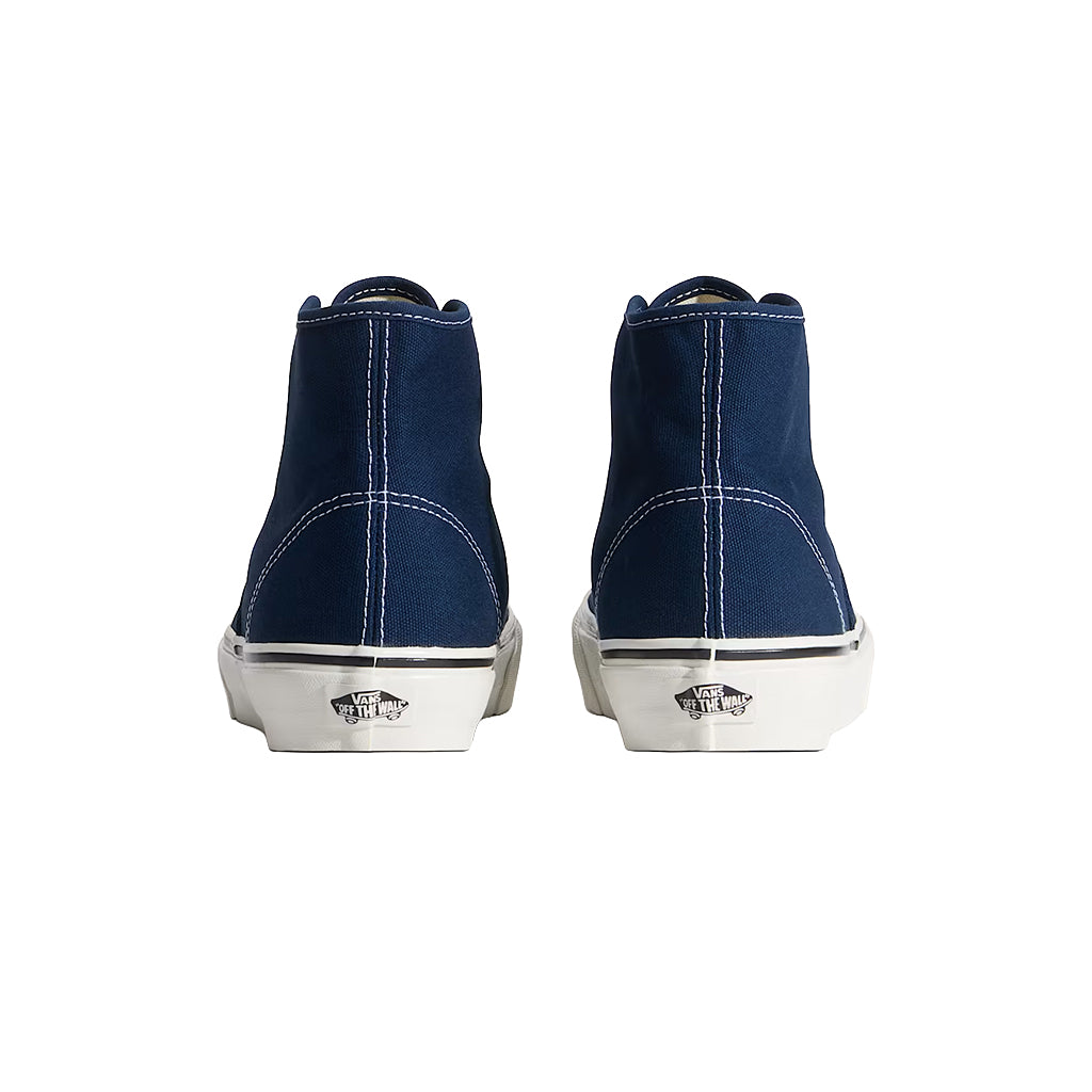 Pair of navy high-top sneakers with white soles on a white background
