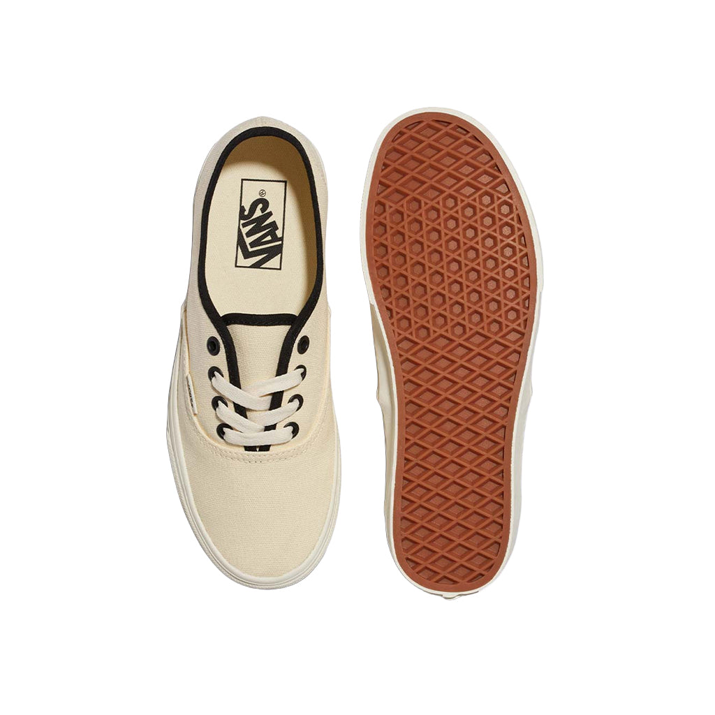 Beige sneaker with brown sole on a white background