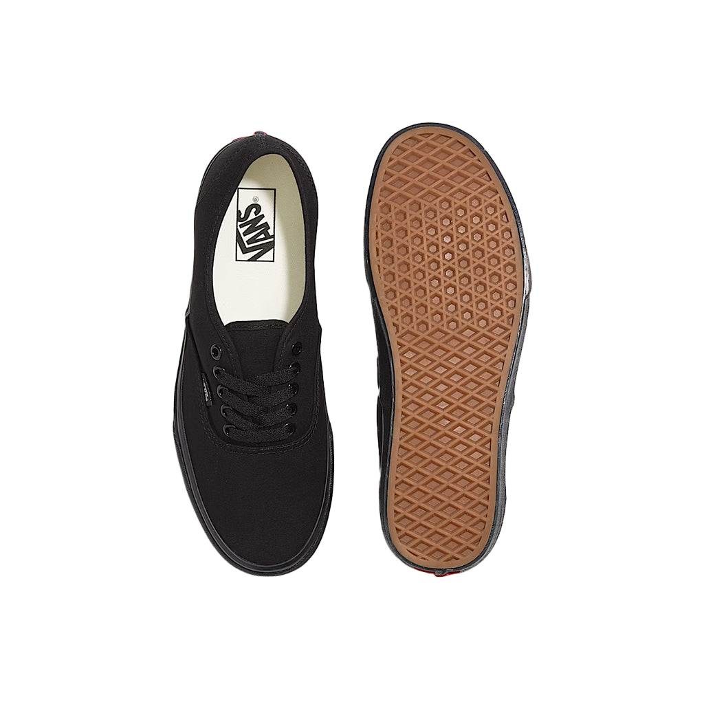 Black sneaker with brown sole on a white background