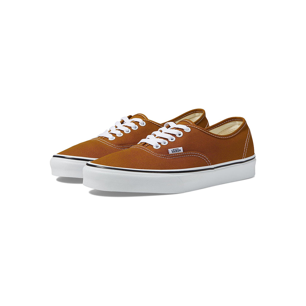 Pair of brown sneakers with white laces on a white background