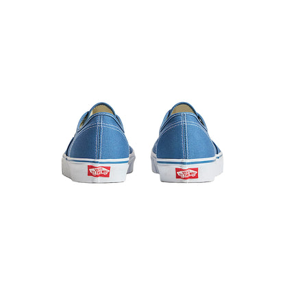 Blue Vans sneakers on a light beige background