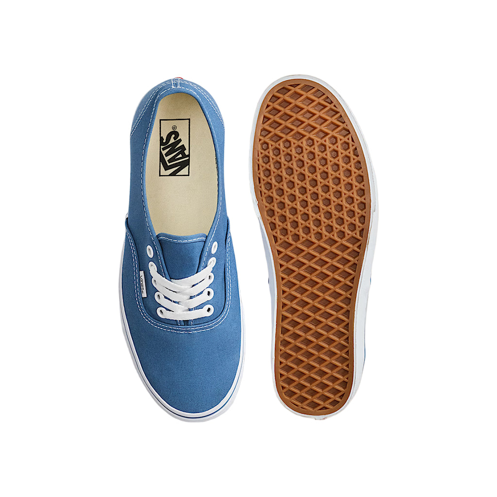 Blue sneaker with white laces on a light gray background