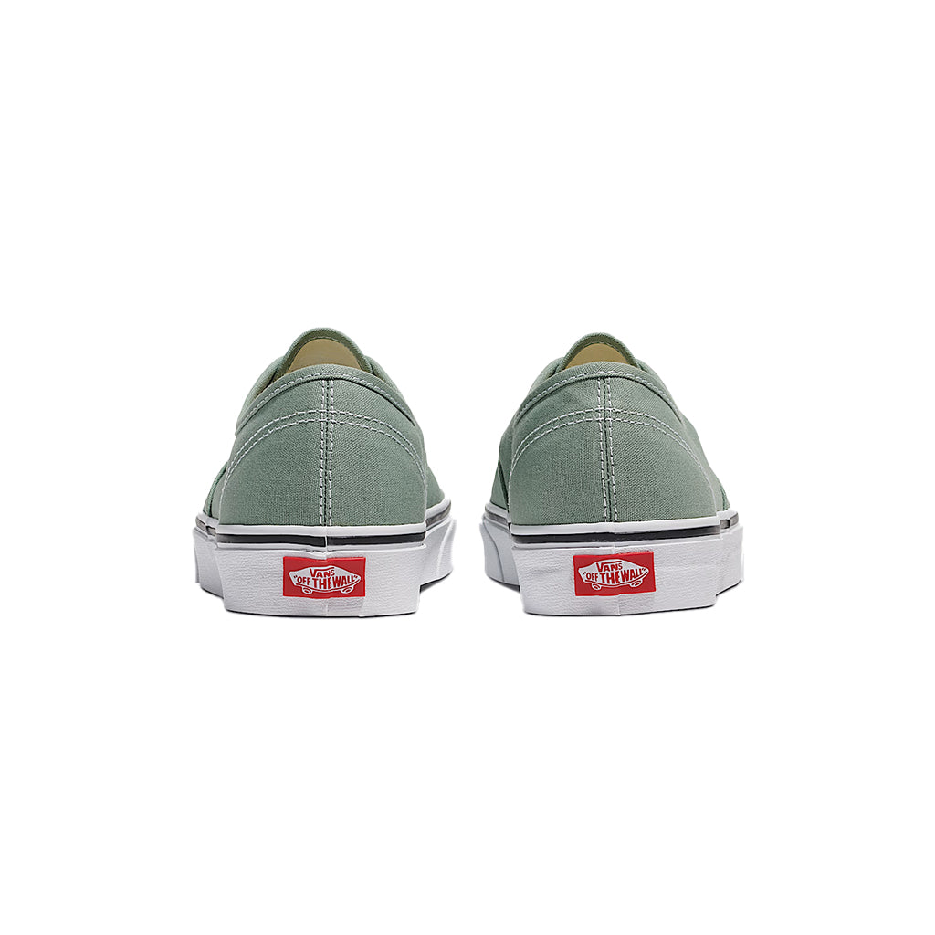 Pair of green sneakers with Vans logo on a white background
