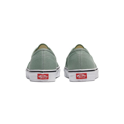 Pair of green sneakers with Vans logo on a white background