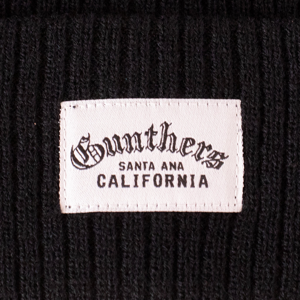 Close-up of a label on a black textured background with 'Gunther's Santa Ana California' text.