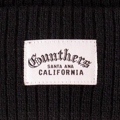 Close-up of a label on a black textured background with 'Gunther's Santa Ana California' text.