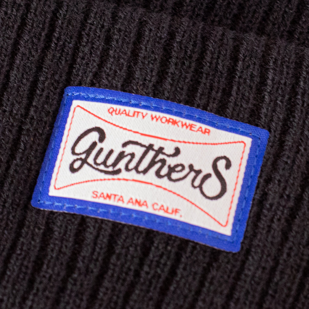 Close up of Gunthers brand logo on a black beanie 