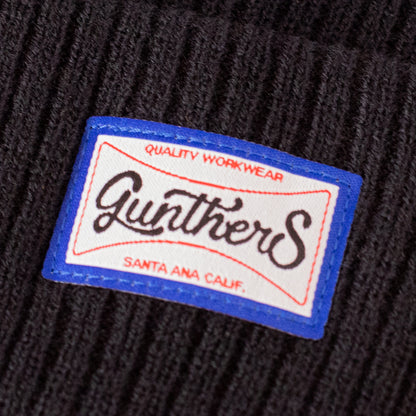 Close up of Gunthers brand logo on a black beanie 