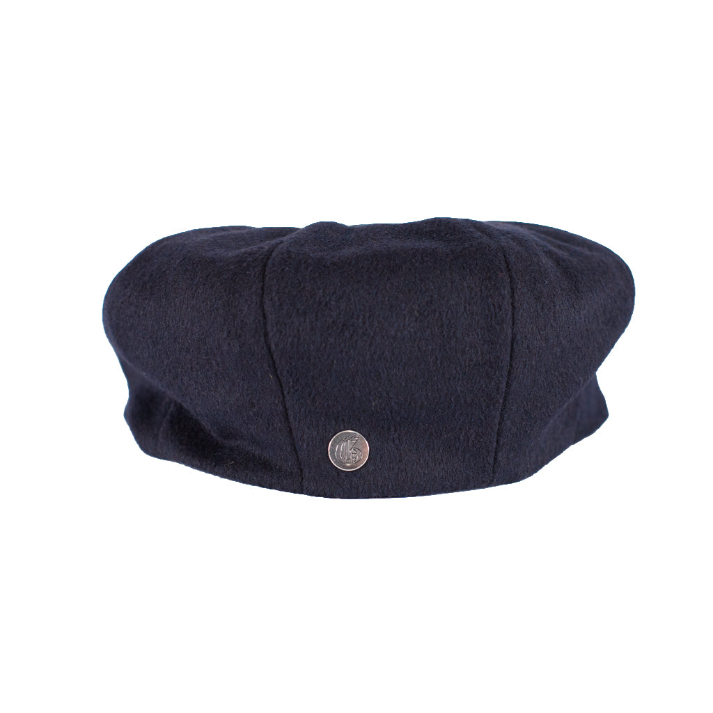 Navy blue flat cap with a button on a white background