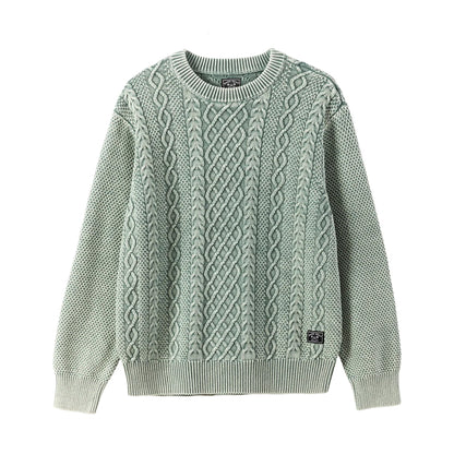 Green cable knit sweater on a white background