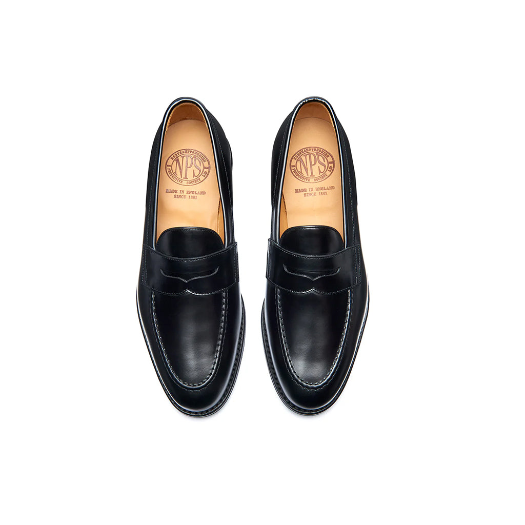 Pair of black loafers with visible brand logo on a white background