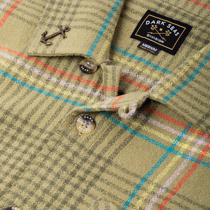 Close-up of a plaid shirt with a 'Dark Seas Division' label.
