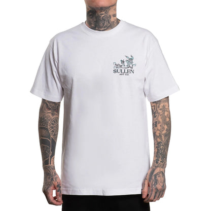 White t-shirt with a logo on the chest worn by a person with tattoos.