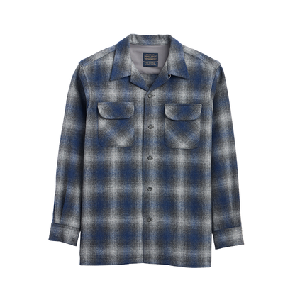 A long-sleeve button-up flannel shirt with a blue, gray, and white plaid pattern, featuring two chest pockets and a spread collar, shown against a plain white background.