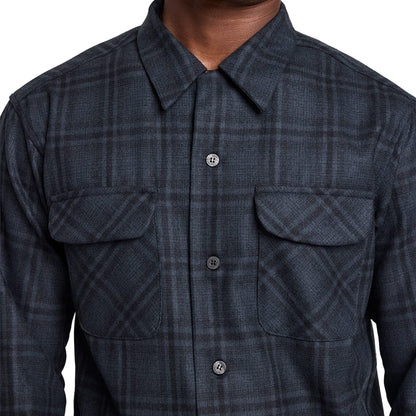Dark plaid shirt with button details on a neutral background