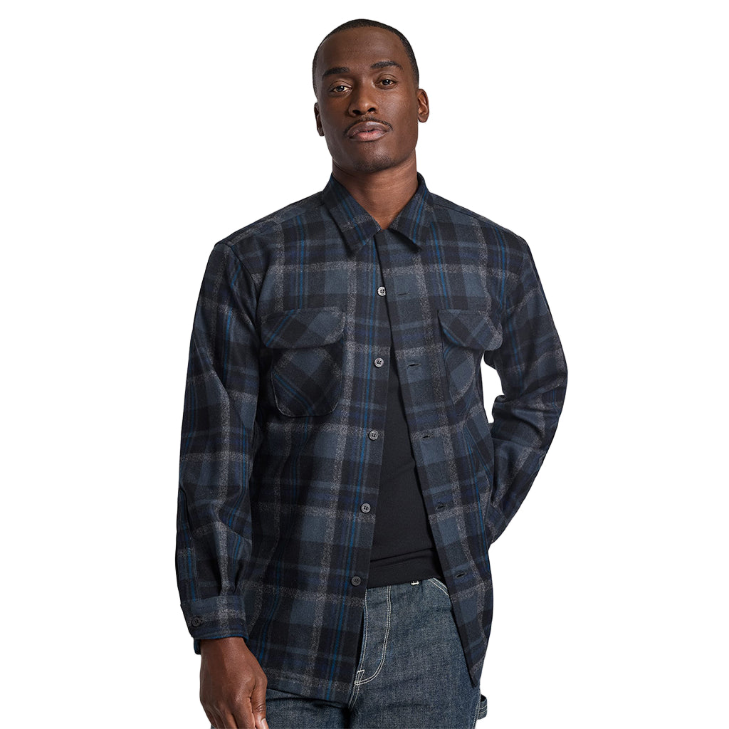 Man wearing a blue plaid shirt against a plain background