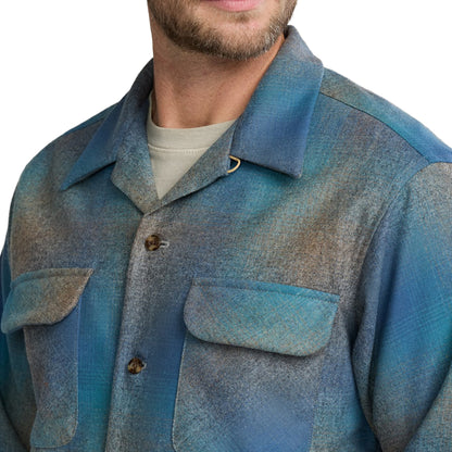 Blue textured jacket worn by a person on a white background