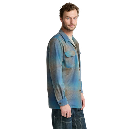 Man wearing a blue patterned shirt on a white background