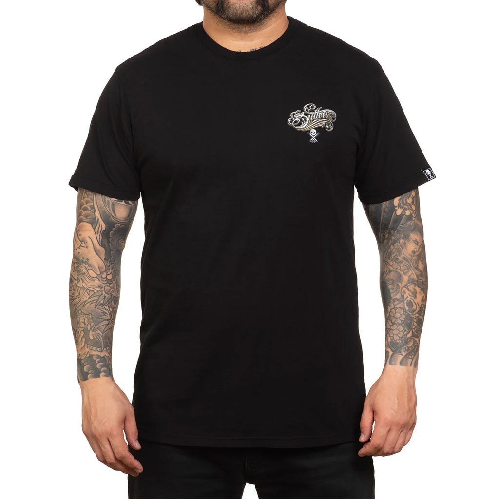 Person wearing a black t-shirt with a logo on the chest against a white background