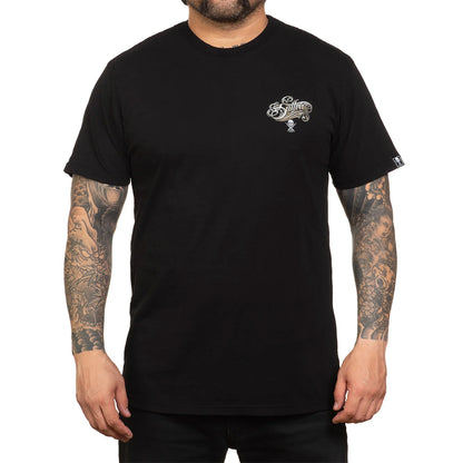 Person wearing a black t-shirt with a logo on the chest against a white background