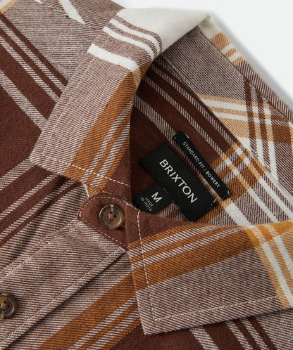 Close-up of a plaid shirt with a Brixton label on a white background