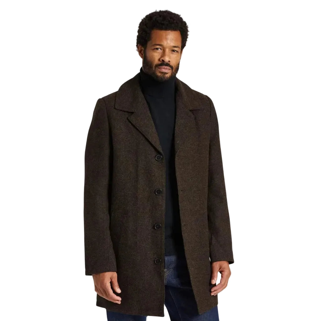 A man wearing a dark brown textured wool-blend overcoat over a black turtleneck sweater and dark blue jeans, standing against a white background.