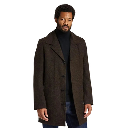 A man wearing a dark brown textured wool-blend overcoat over a black turtleneck sweater and dark blue jeans, standing against a white background.