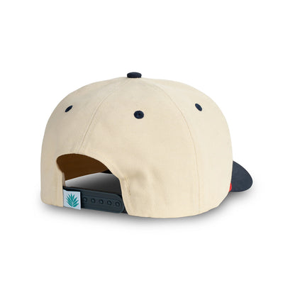 Beige cap with black brim and logo on a white background