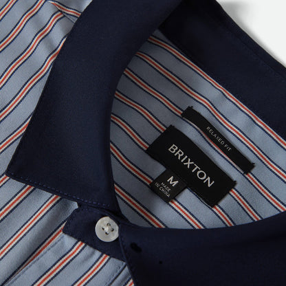 Close-up of a shirt with a Brixton label on a white background