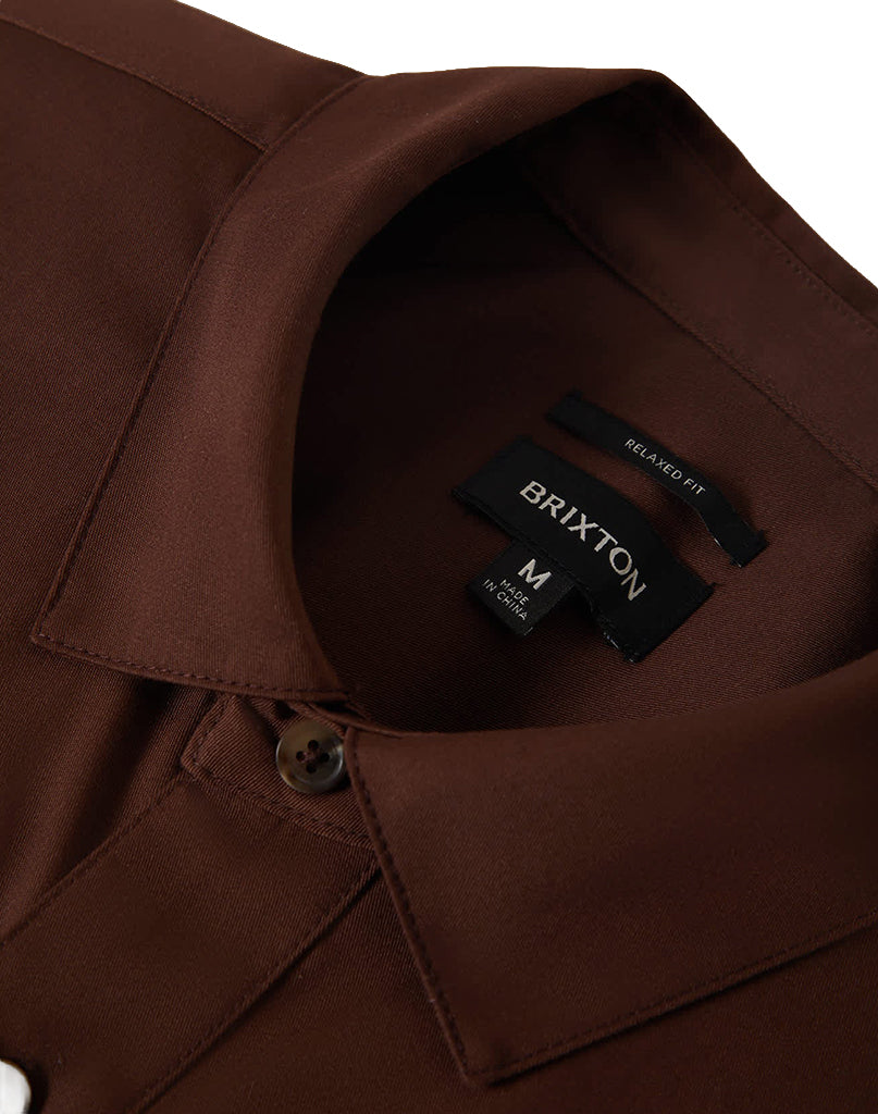 Close-up of a brown shirt collar with a Brixton label.