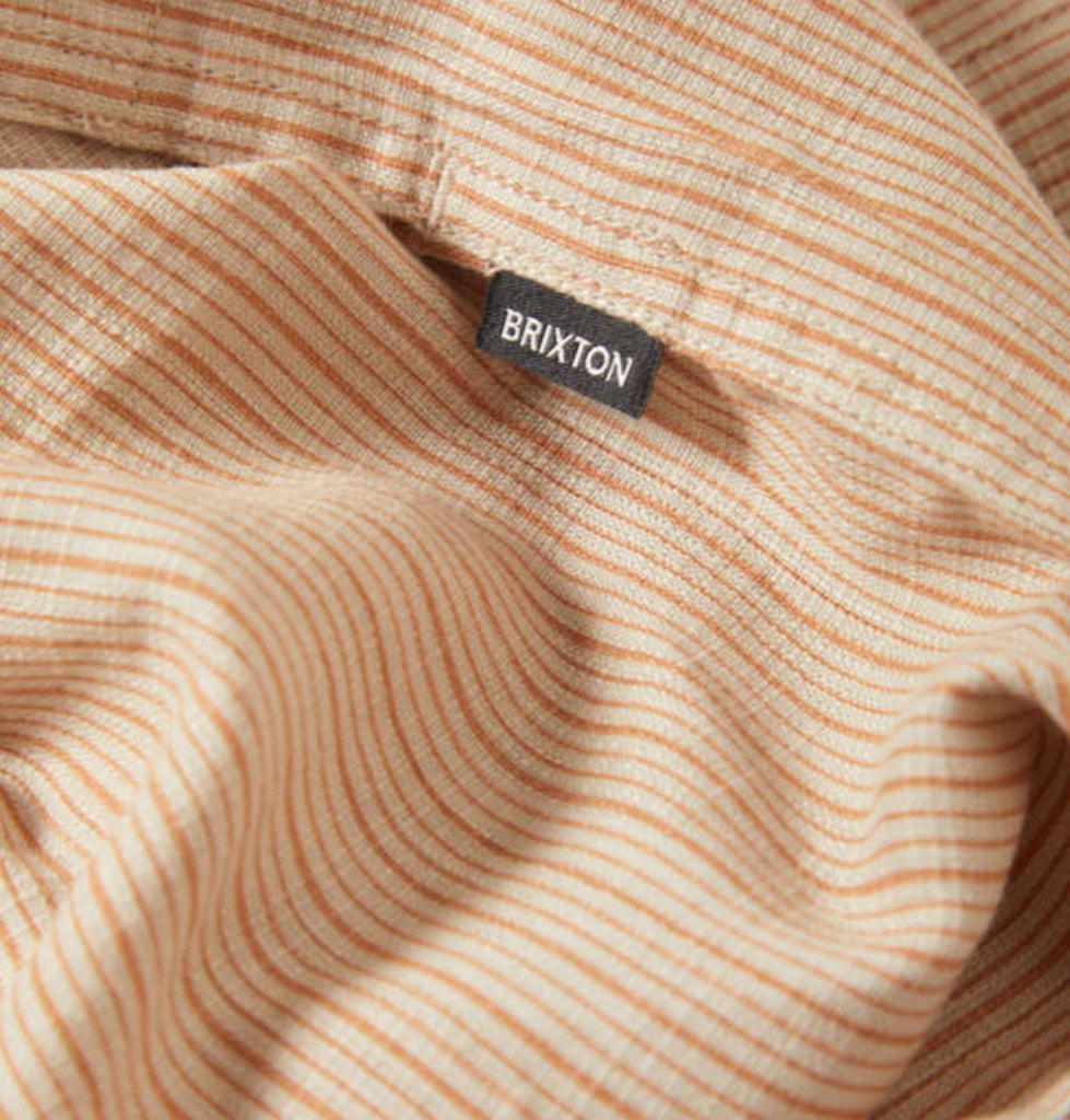 Close-up of a brown and beige striped fabric with a Brixton label.