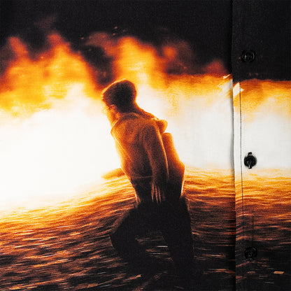 Person standing by a door with a fiery background