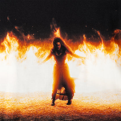 Person in a long dress surrounded by flames on a dark background