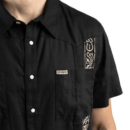 Black shirt with white embroidery and 'Sendero' label on a white background