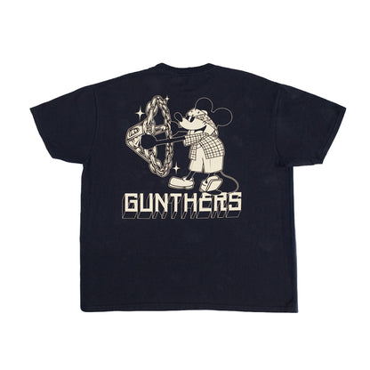 A black short-sleeve t-shirt shown from the back, featuring a large cream-colored graphic of a cartoon mouse wearing a plaid shirt and holding a chainsaw, with the word 'GUNTHERS' printed below.
