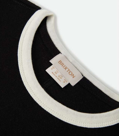 Close-up of a black shirt with white trim and a Brixton label.